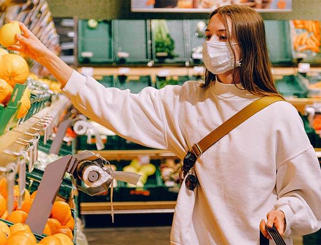 Customer selecting produce at a grocery store